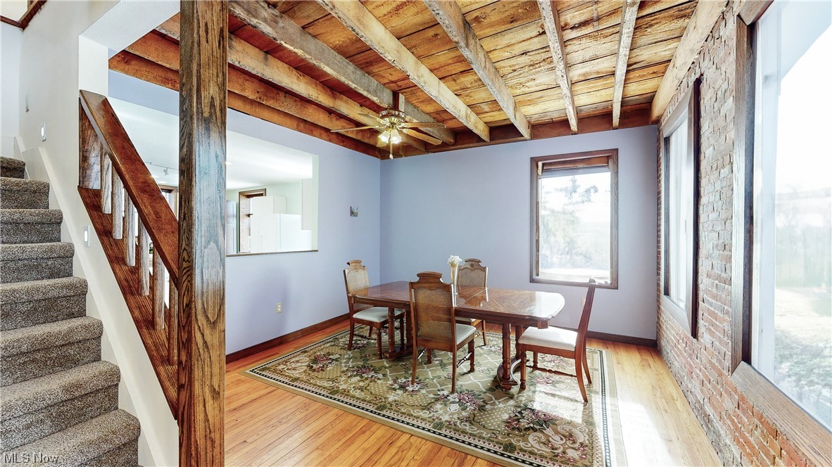 5770 Horning Road Kent, OH 44240 - Photo 10 of 50 Dining area featuring beamed ceiling, brick wall, ceiling fan, light hardwood flooring, and wood beamed ceiling