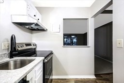 30 High Street, Unit 209 Dedham, MA 02026 - Photo 11 of 28 a kitchen with a sink and a refrigerator