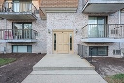30 High Street, Unit 209 Dedham, MA 02026 - Photo 25 of 28 a front view of a house with a garden