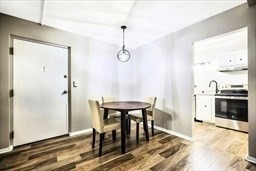 30 High Street, Unit 209 Dedham, MA 02026 - Photo 7 of 28 a view of a dining room with furniture window and wooden floor