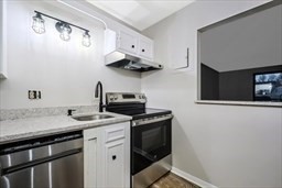 30 High Street, Unit 209 Dedham, MA 02026 - Photo 9 of 28 a kitchen with stainless steel appliances a sink and a stove