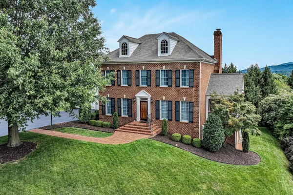a front view of a house with a yard table and chairs