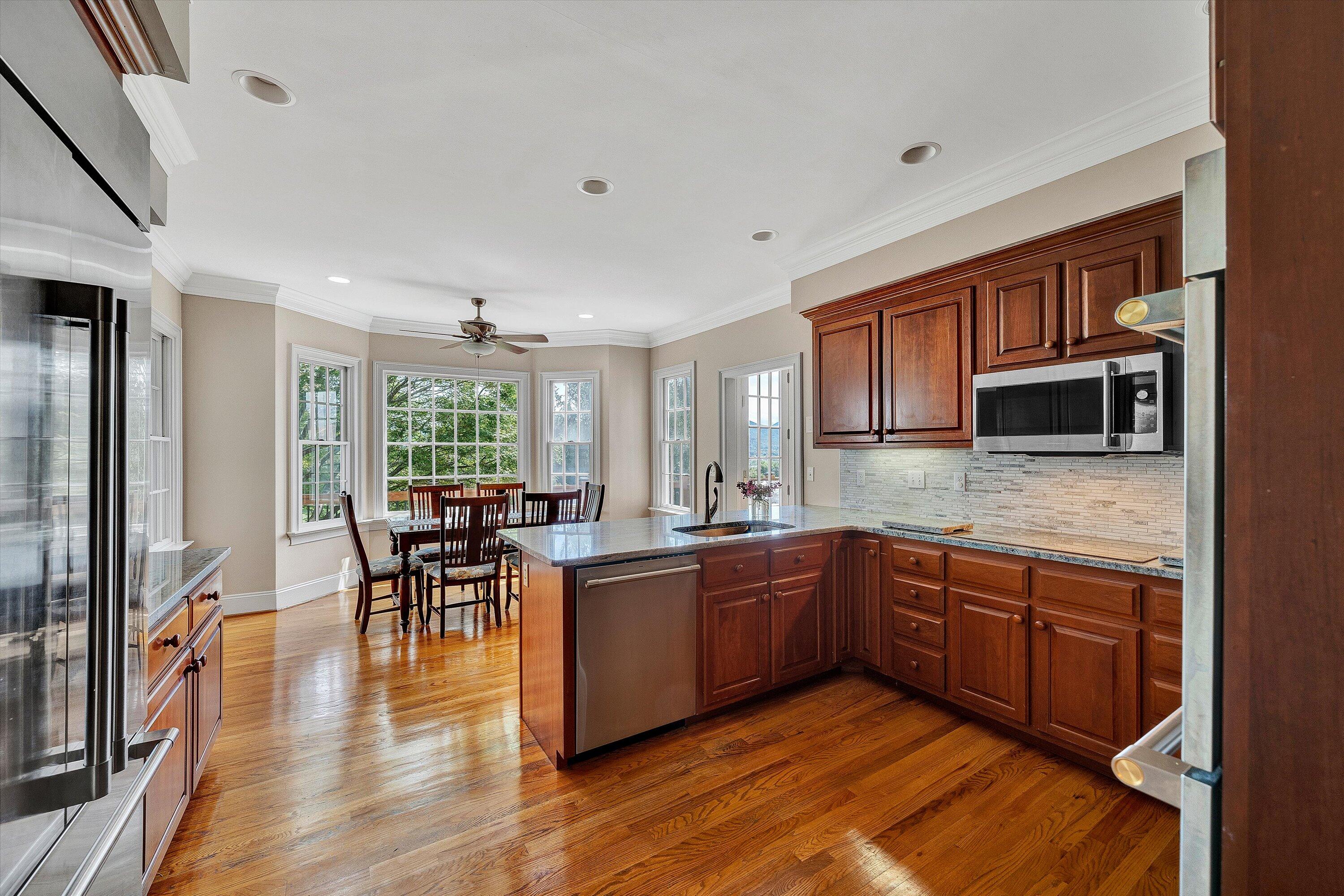 824 Pendleton Drive Salem, VA 24153 - Photo 23 of 78 a large kitchen with lots of counter space dining table and stainless steel appliances