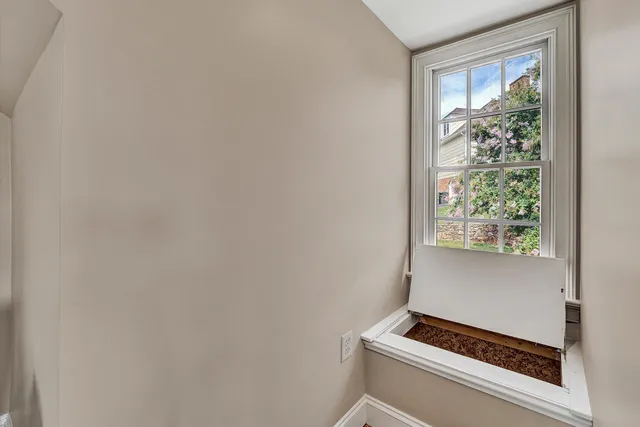a room with wooden floor and pool table