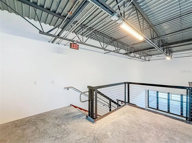 a view of a balcony with floor to ceiling windows