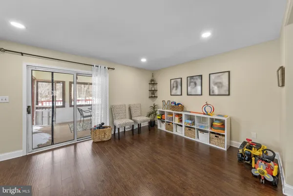 a kitchen with stainless steel appliances a dining table chairs stove and refrigerator