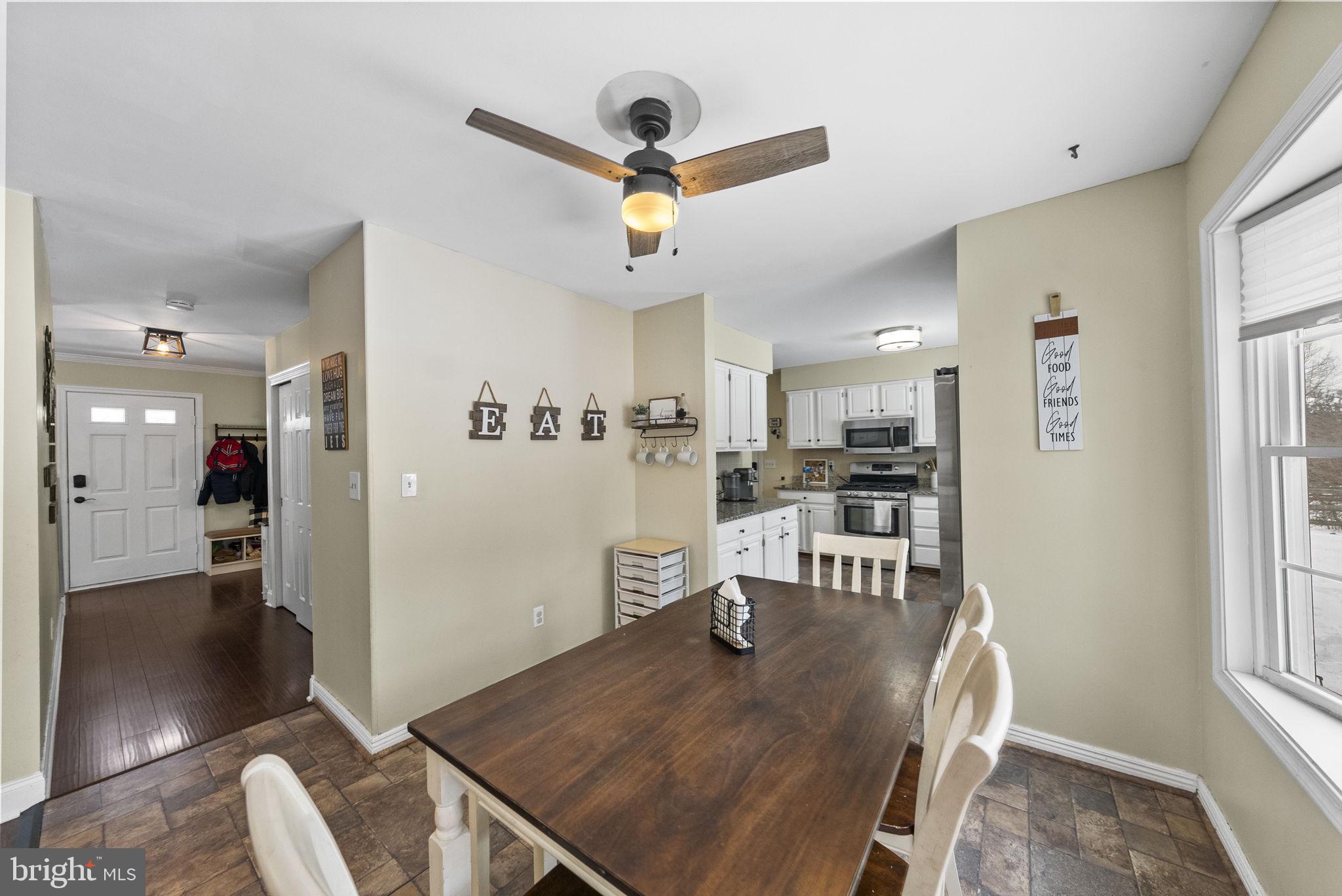 4 Birch Run Court Ewing, NJ 08628 - Photo 19 of 57 a view of a dining room and livingroom with furniture wooden floor a rug a fireplace