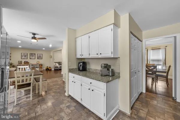 a kitchen with granite countertop cabinets stainless steel appliances a sink and a counter space