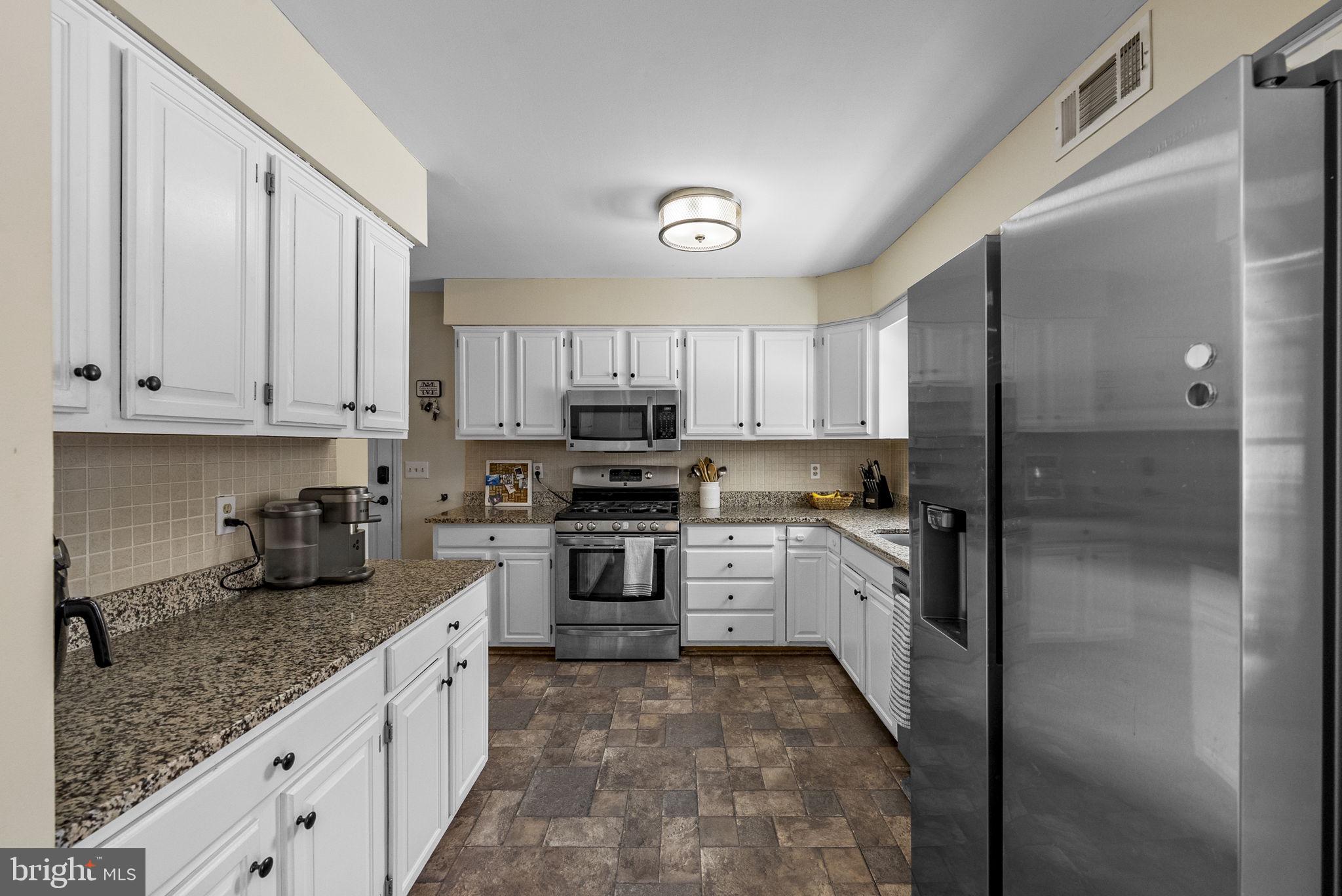4 Birch Run Court Ewing, NJ 08628 - Photo 22 of 57 a kitchen with granite countertop cabinets stainless steel appliances a sink and a counter space