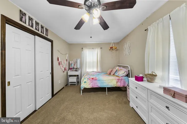 a bedroom with a bed and a baby crib