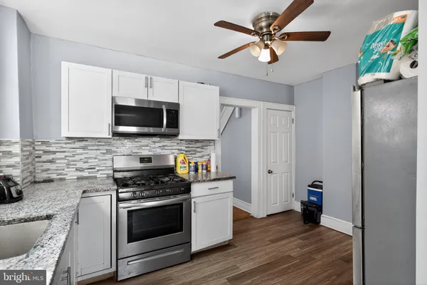 a kitchen with stainless steel appliances a stove a sink and a refrigerator