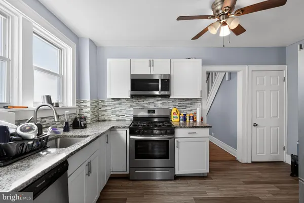 a kitchen with a sink stove and microwave