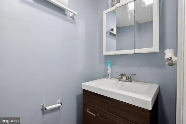 a bathroom with a sink vanity and a mirror
