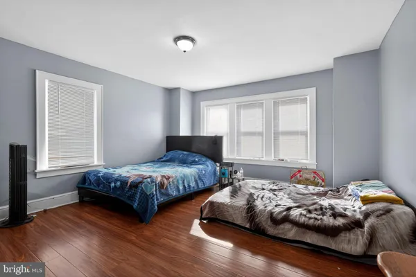 a bedroom with two beds and a window