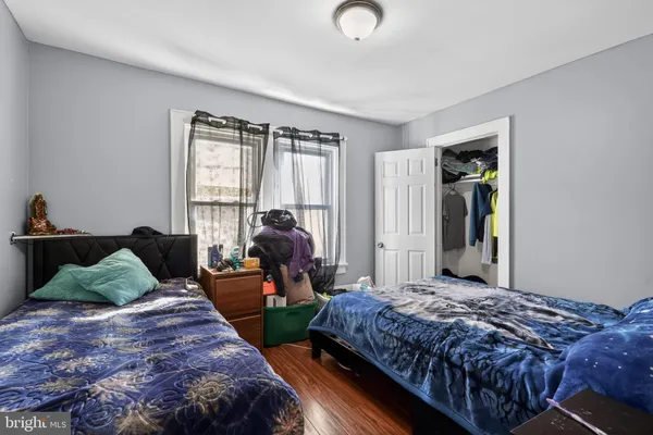 a bedroom with bed and large windows