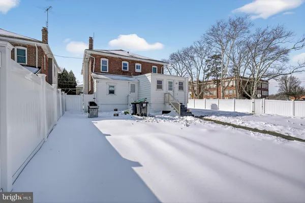 a view of residential houses with snow on the road