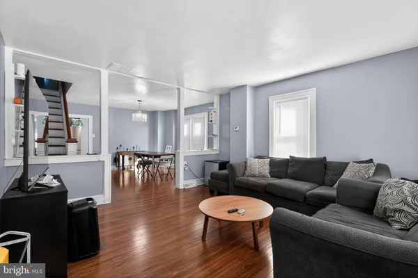 a living room with furniture and wooden floor