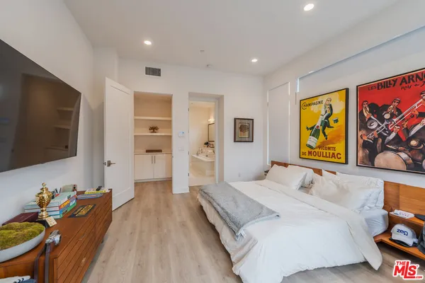 a spacious bedroom with a bed and furniture