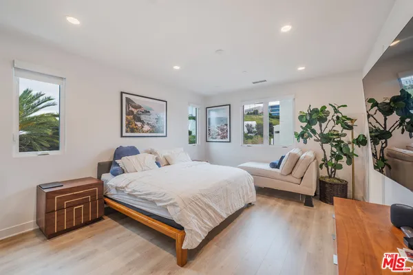 a bedroom with a bed and a couch