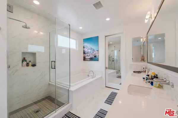 a bathroom with a tub a sink and a shower