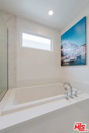a bathroom with a bathtub and a sink