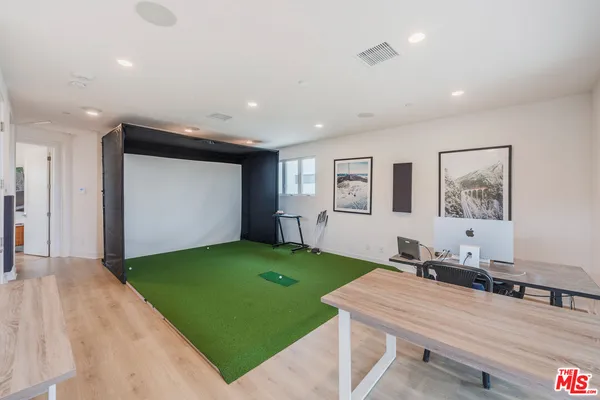 a room with pool table and windows