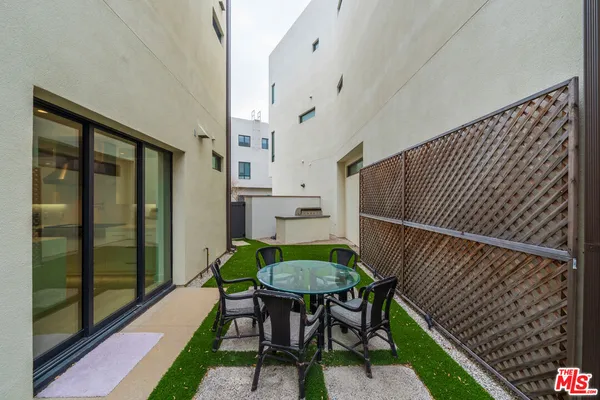 a balcony with table and chairs