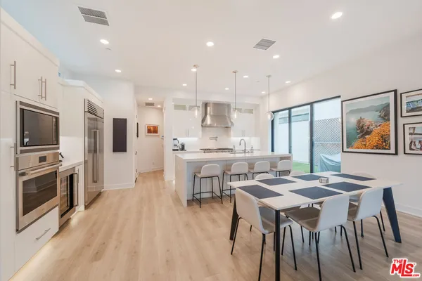 a large kitchen with a table and chairs