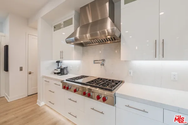 a kitchen with cabinets and stove