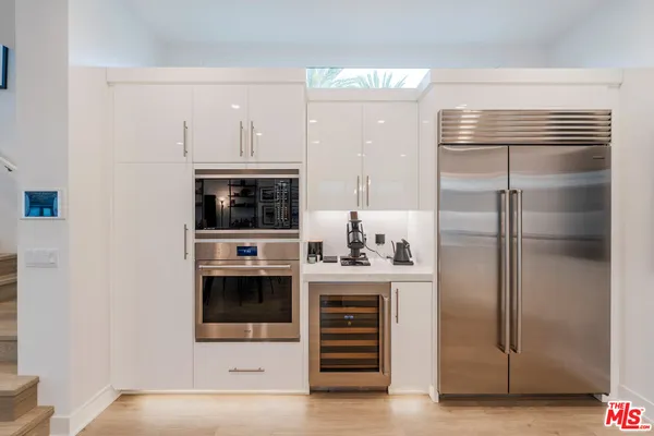 a kitchen with a refrigerator and a stove