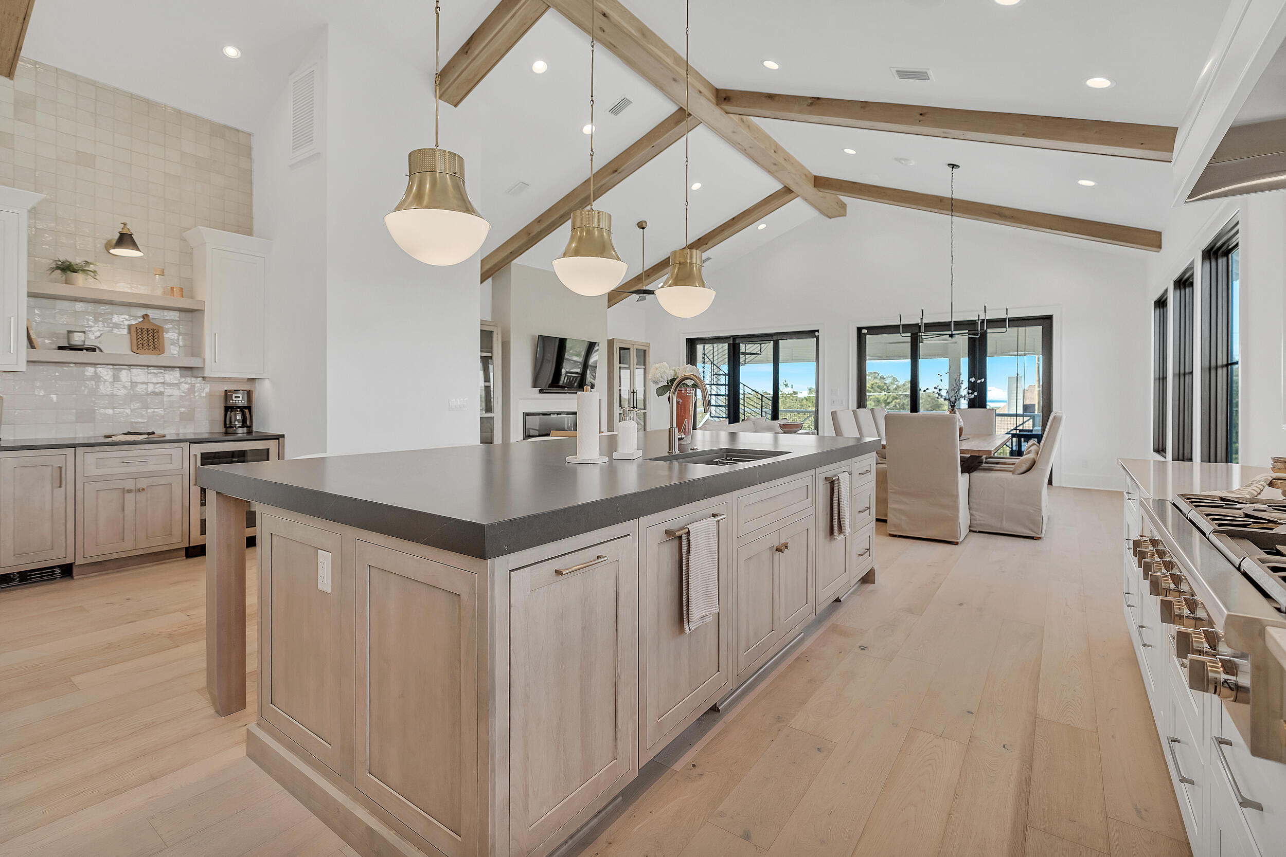 7843 East County Highway 30A Inlet Beach, FL 32461 - Photo 17 of 71 a large white kitchen with a large island oven a sink and stainless steel appliances