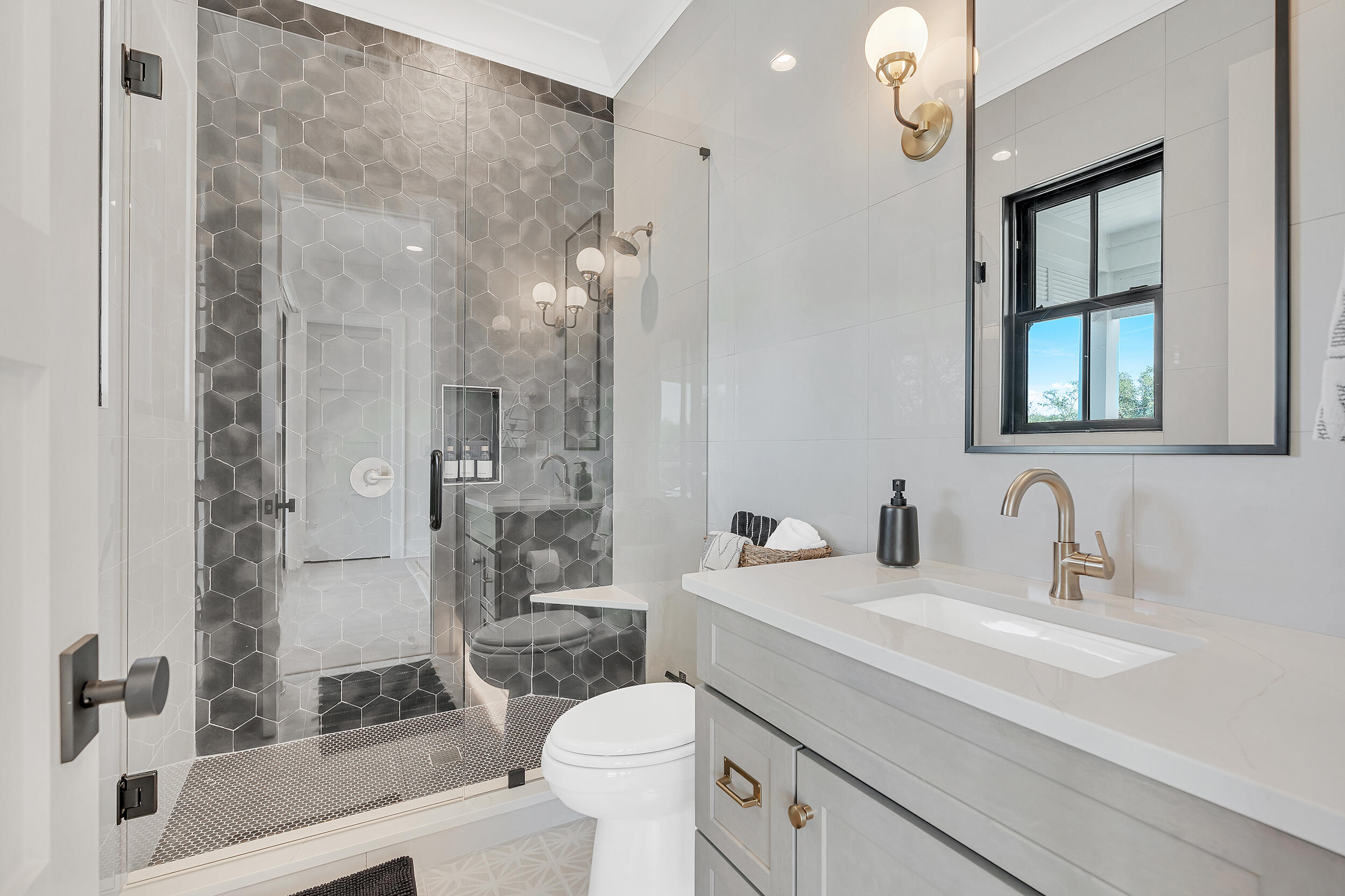 7843 East County Highway 30A Inlet Beach, FL 32461 - Photo 36 of 71 a bathroom with a sink a toilet a large mirror and shower