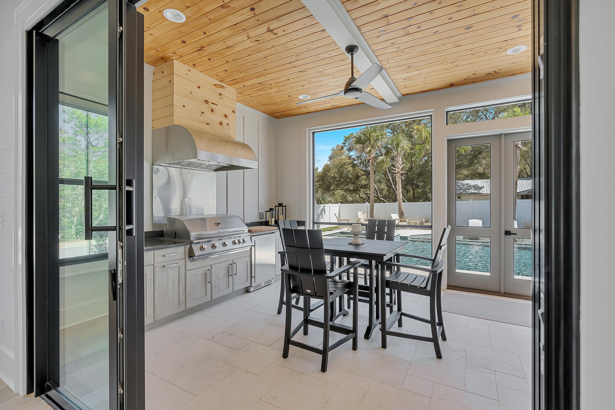 7843 East County Highway 30A Inlet Beach, FL 32461 - Photo 52 of 71 a kitchen with a table chairs and refrigerator
