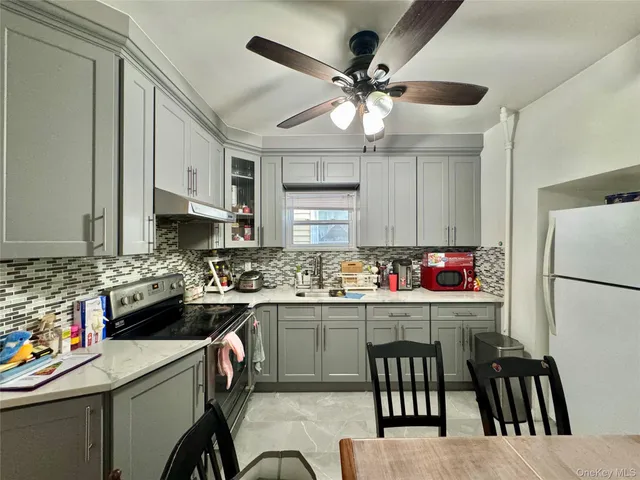 a kitchen with a cabinets a sink a stove a oven a dining table and chairs