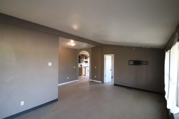 a view of a hallway with wooden shelves