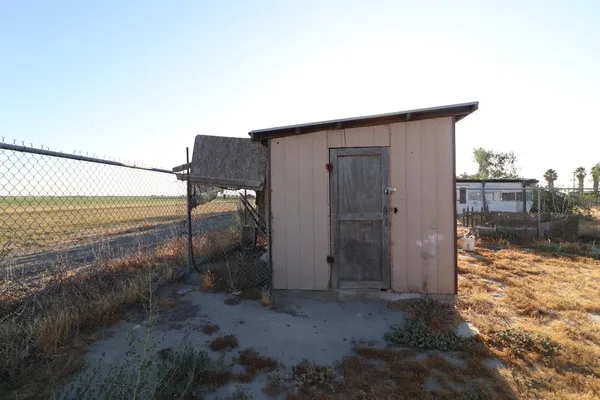 a pathway of a house with a yard