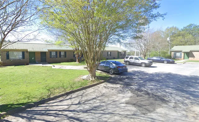 a view of a yard with cars