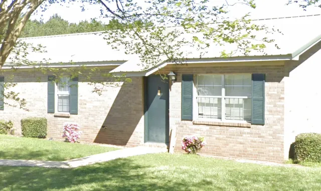 a view of a front of a house with a yard