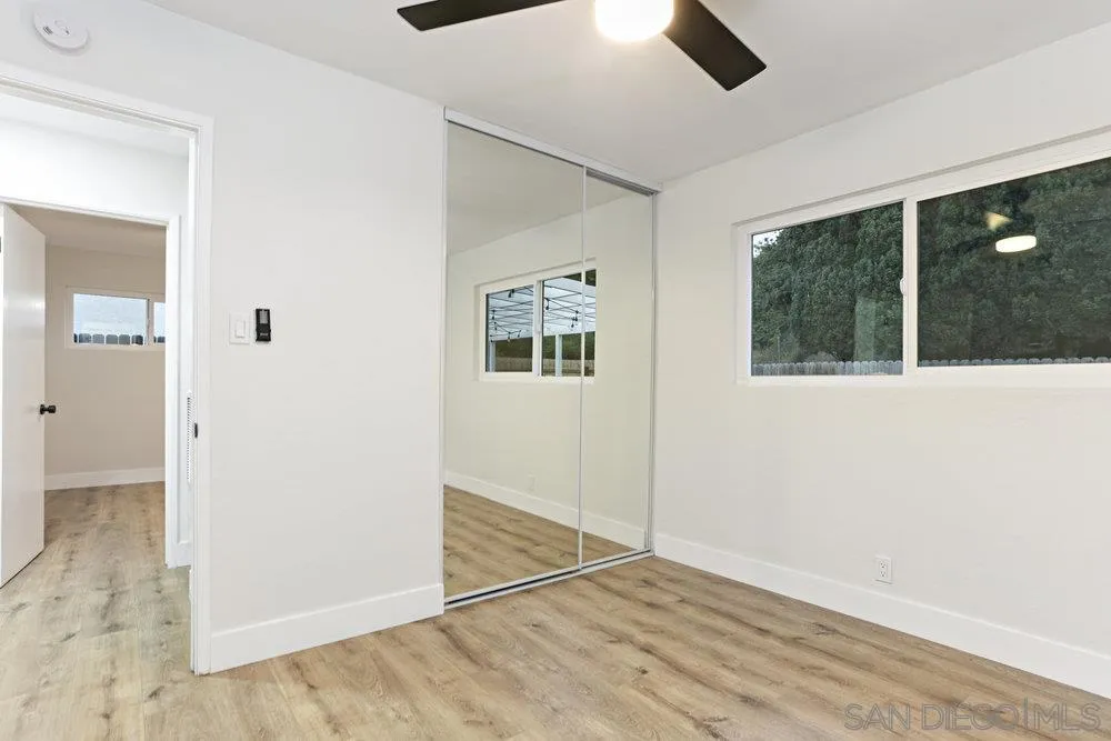 3255 Roberta Lane Oceanside, CA 92054 - Photo 13 of 24 an empty room with wooden floor and windows
