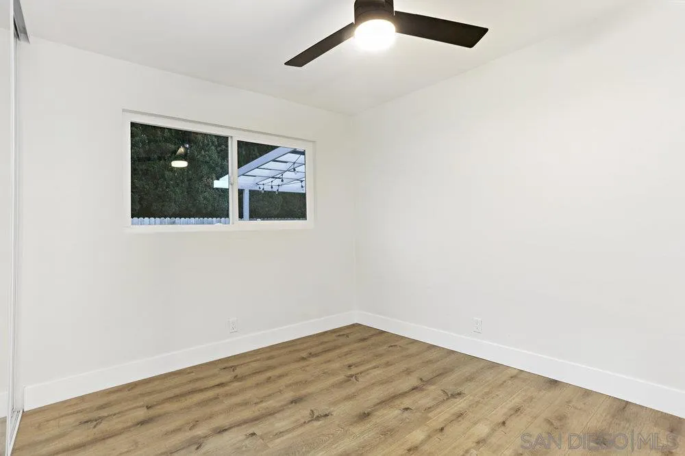 3255 Roberta Lane Oceanside, CA 92054 - Photo 14 of 24 an empty room with wooden floor and windows