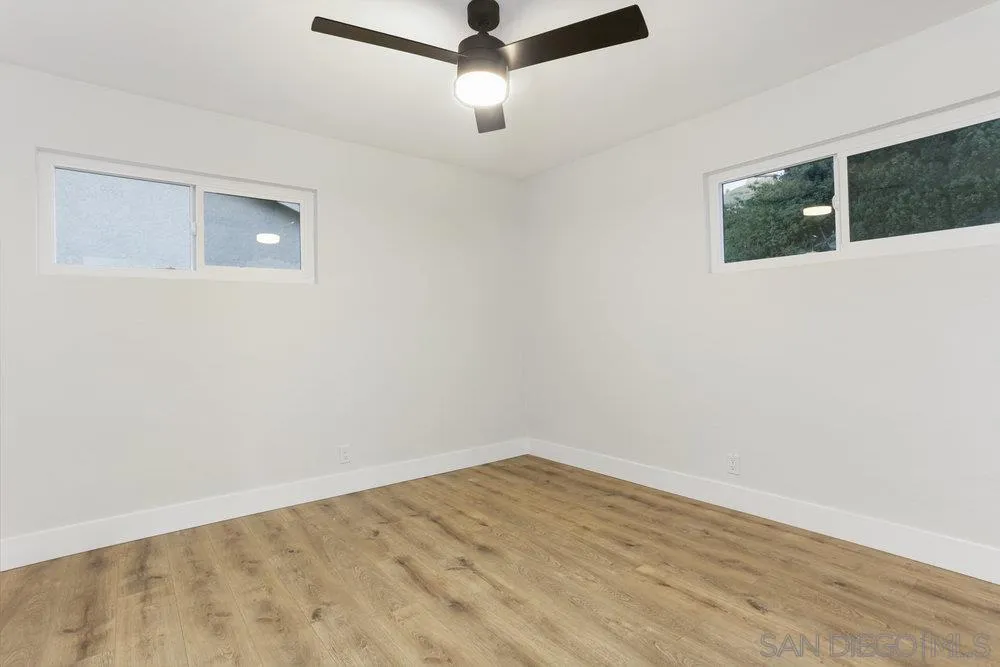 3255 Roberta Lane Oceanside, CA 92054 - Photo 17 of 24 a view of an empty room with wooden floor and a ceiling fan