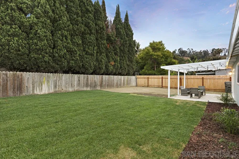 3255 Roberta Lane Oceanside, CA 92054 - Photo 19 of 24 a view of a backyard with seating area and trees in the background