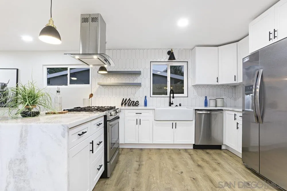 3255 Roberta Lane Oceanside, CA 92054 - Photo 3 of 24 a kitchen with a sink stove and refrigerator