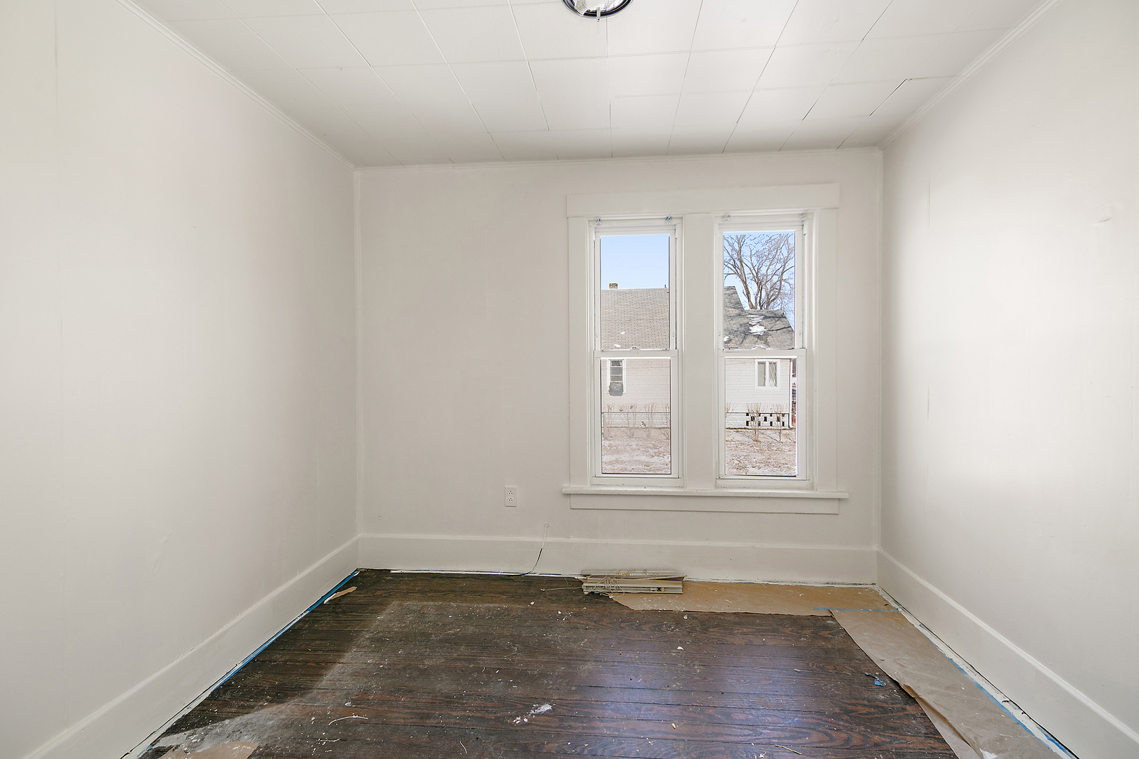 201 North Cottage Avenue Kankakee, IL 60901 - Photo 4 of 13 an empty room with wooden floor and window