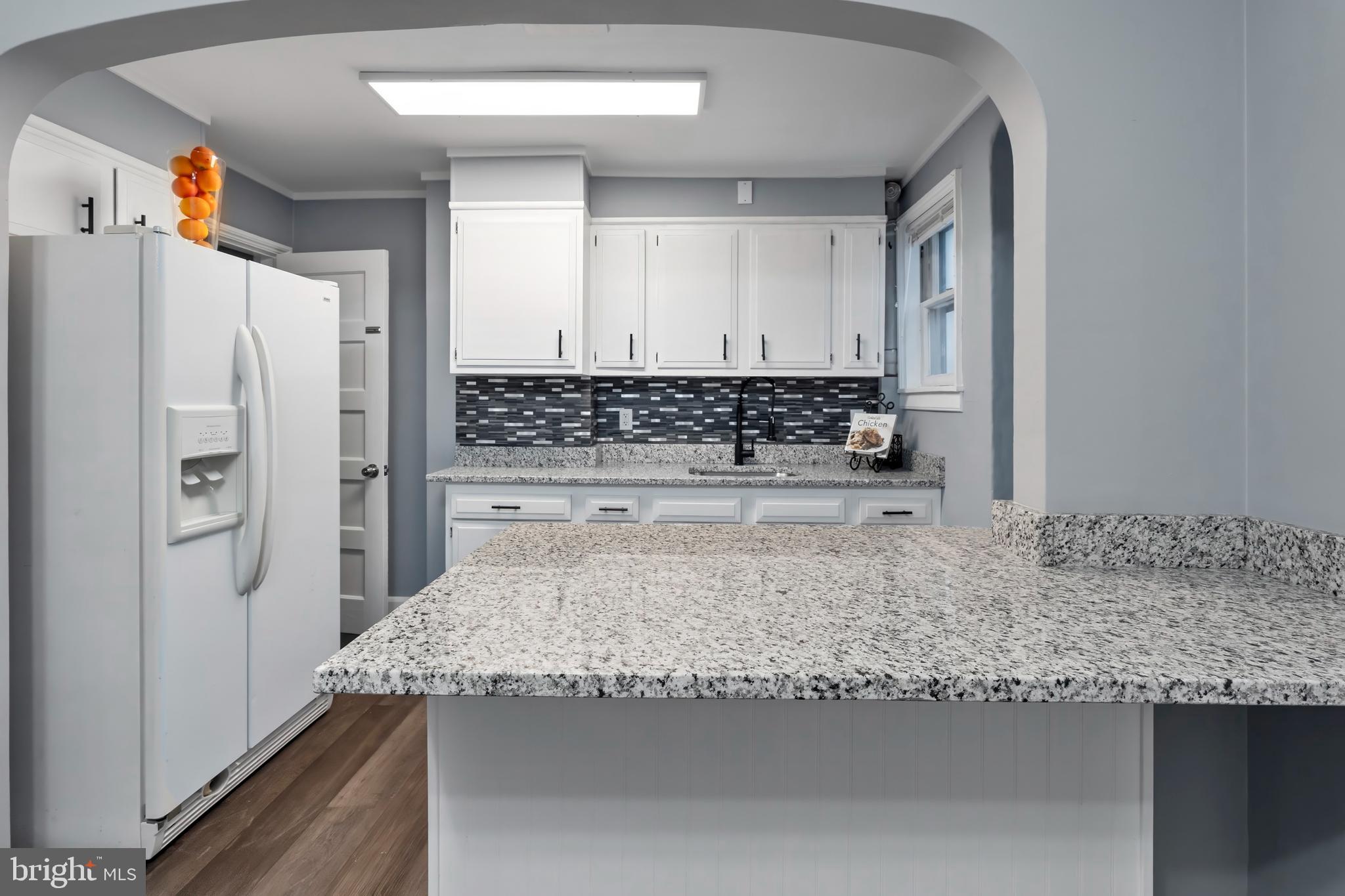 55 Kinship Road Baltimore, MD 21222 - Photo 12 of 42 a kitchen with granite countertop a refrigerator and a sink