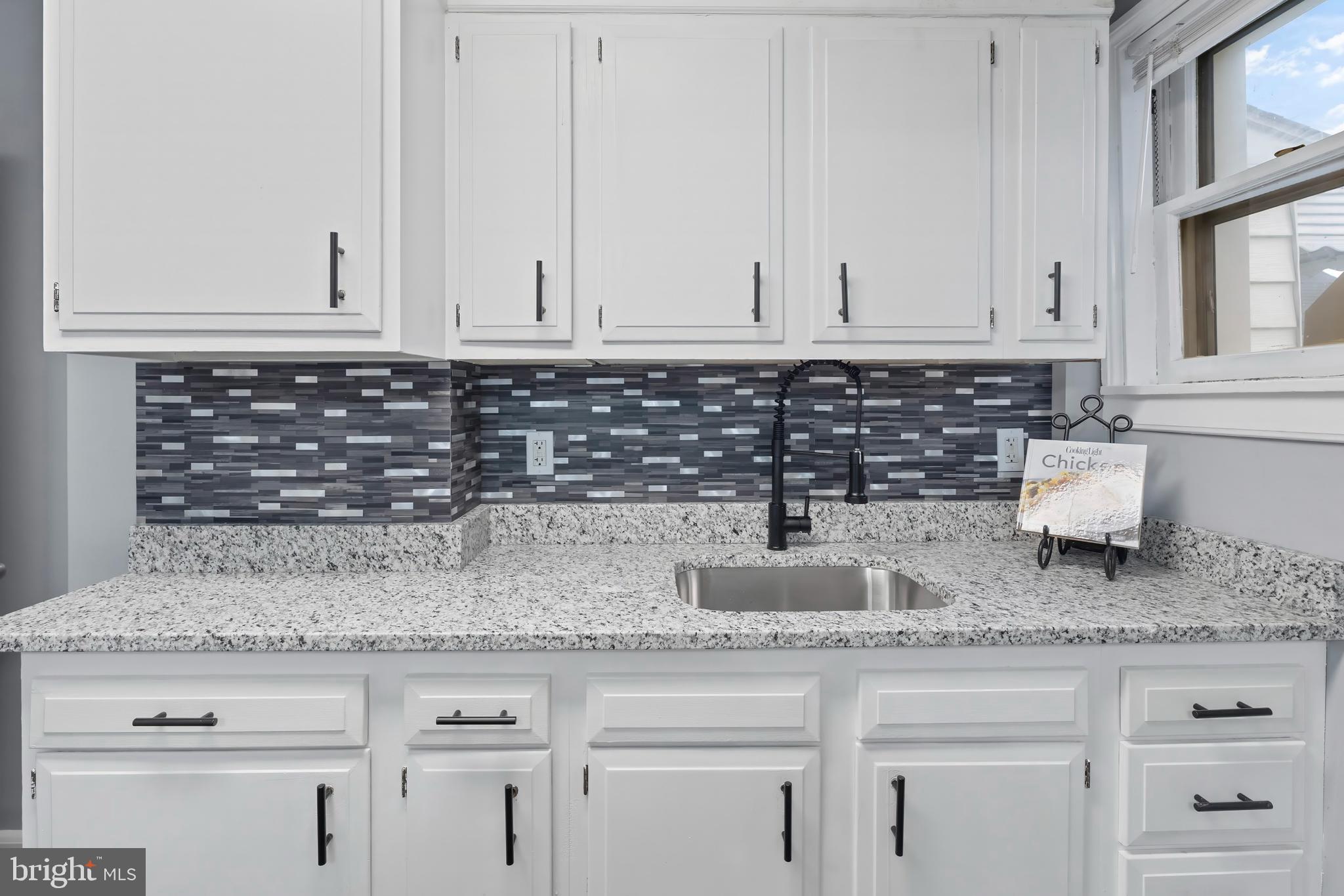 55 Kinship Road Baltimore, MD 21222 - Photo 15 of 42 a kitchen with granite countertop white cabinets and a white stove