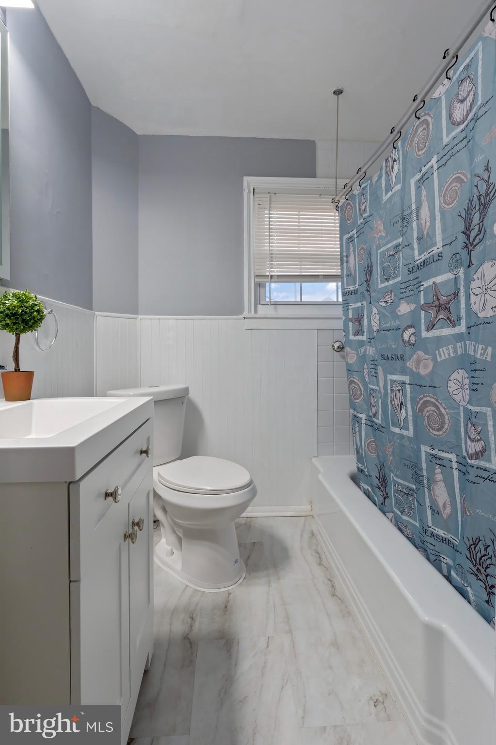 55 Kinship Road Baltimore, MD 21222 - Photo 19 of 42 a bathroom with a sink a toilet and shower