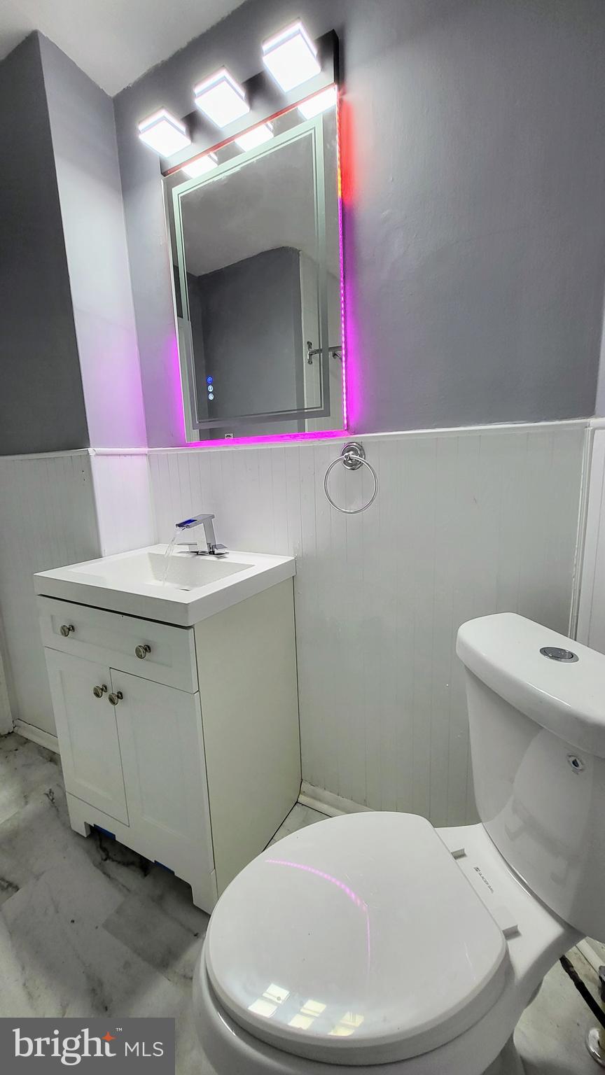 55 Kinship Road Baltimore, MD 21222 - Photo 20 of 42 a bathroom with a toilet a sink a mirror and vanity