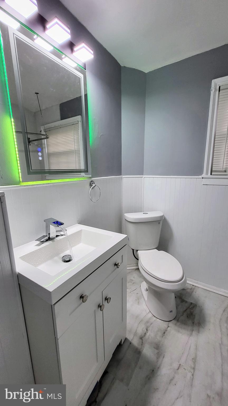 55 Kinship Road Baltimore, MD 21222 - Photo 21 of 42 a bathroom with a toilet sink and mirror