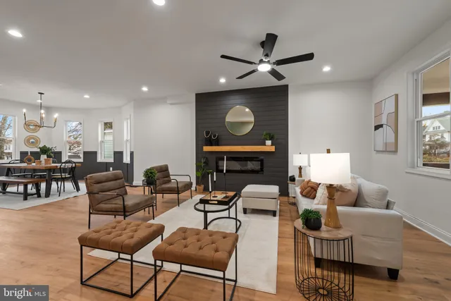 a living room with furniture kitchen view and a window